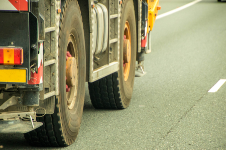 A closeup of a large truck's wheels, in motion.の写真素材