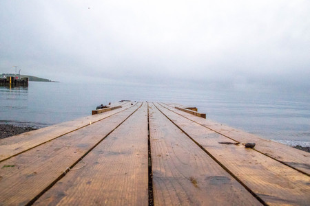 A look along a wooden walkway, into the sea.