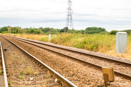 A set of railway tracks running through the countryside.の写真素材