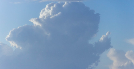 A view across the skies at fluffy clouds forming.