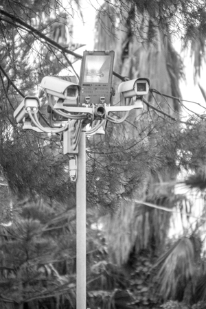 A cluster of CCTV cameras on a post keeping the security of a housing complex.の写真素材