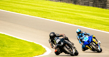 Motorbikes race around the famous track at Cadwell Park, in England, UK.のeditorial素材