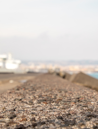 A view along a harbor wall, in Catania, Italy.