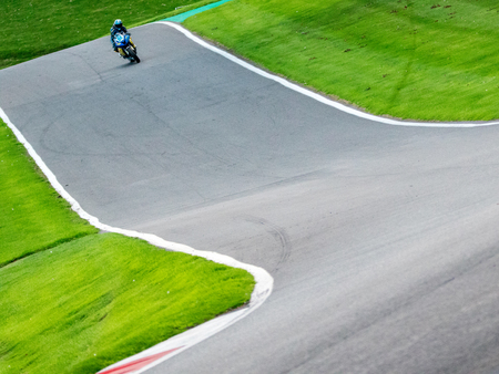 Motorbikes race around the famous track at Cadwell Park, in England, UK.のeditorial素材