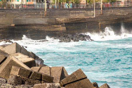The coast of Catania harbor being battered by large waves during bad weather.の写真素材