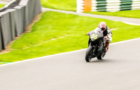 Motorbikes race around the famous track at Cadwell Park, in England, UK.のeditorial素材