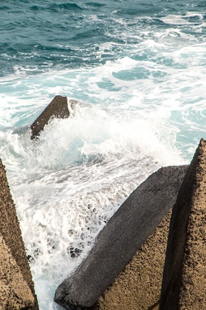 The coast of Catania harbor being battered by large waves during bad weather.