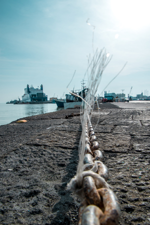 A view from the ground looking alone harbor wall chains.の写真素材