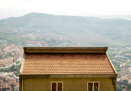 A view from Enna, just of the of the many beautiful towns of Sicily, Italy. A single rooftop in the...