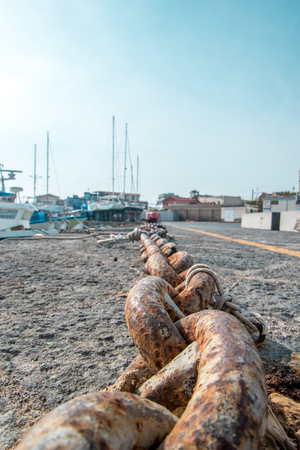 A view from the ground looking alone harbor wall chains.の写真素材