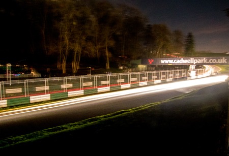 A rally undertaken on a racetrack, carried out at night / dusk.