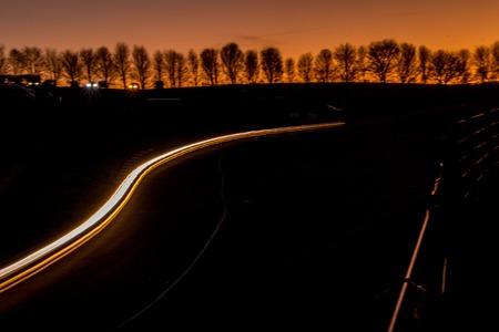 A rally undertaken on a racetrack, carried out at night / dusk.の写真素材