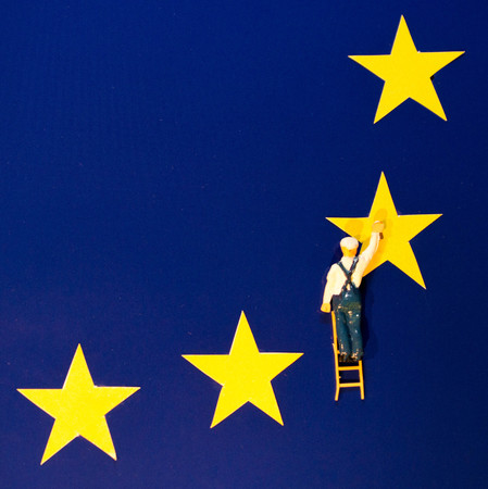 A painter adds/removes the UK's yellow star from the EU flag.の写真素材