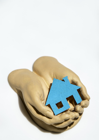 A pair of cupped hands hold and care for property.の写真素材