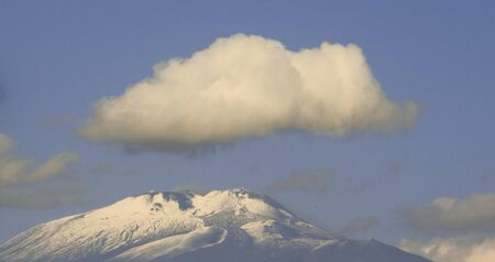 Mount Etna is one of the World's most active volcanoes. Here it is seen covered, at the top, with snow and ice. It's located in Sicily, Italy.の写真素材