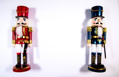 Two colourful Christmas Nutcracker decoration statues on a white background.