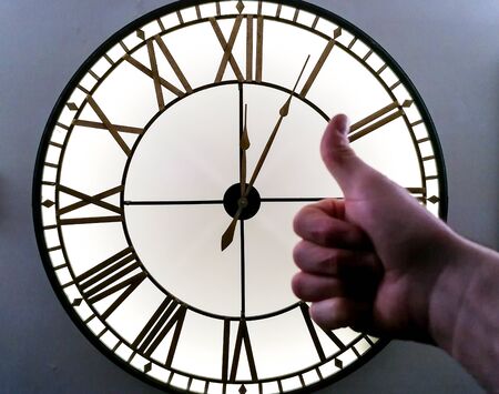 A large wall clock that has just passed the time of midnight, such as new year.の写真素材