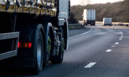 A large HGV travels across country to deliver or collect goods for the next business location.