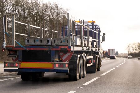 A large HGV travels across country to deliver or collect goods for the next business location.