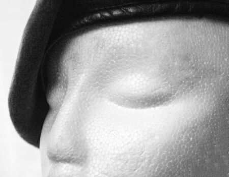 A polystyrene head wearing a Military cadet beret, against a plain white background.の写真素材