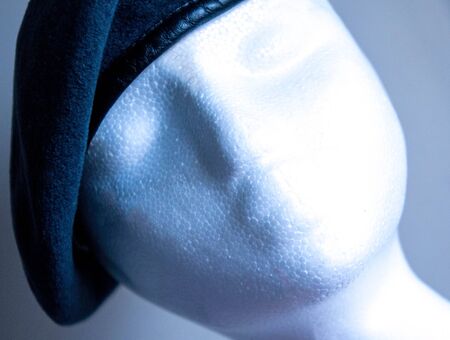 A polystyrene head wearing a Military cadet beret, against a plain white background.の写真素材