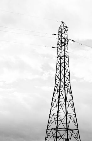 A typical electricity pylon in the United Kingdom. These steel structures hold thick cables that transfer electricity across the land.の写真素材