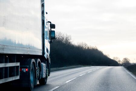 A large HGV travels across country to deliver or collect goods for the next business location.