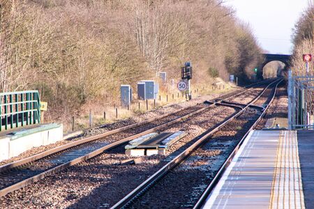 A view along a new train station platform during a sunny day.