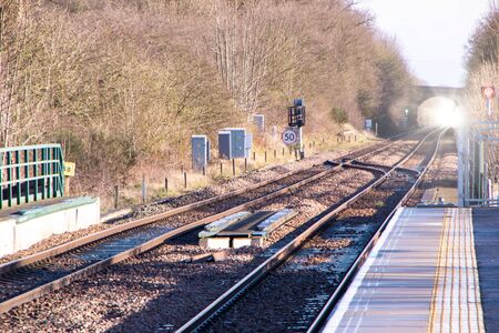 A view along a new train station platform during a sunny day.
