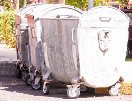 Cardboard boxes and plastic stacked up in a large community recycling bin.の写真素材