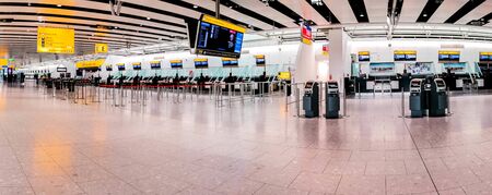 A large airport terminal with no activity due to the pandemic restrictions.の写真素材