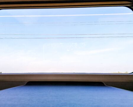 A view from a passenger window seat table as the train races through the British countryside.の写真素材