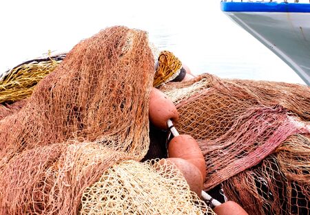 Fishing nets at the side of a harbor, in Sicily, Italy.の写真素材