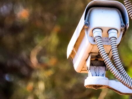 A cluster of CCTV cameras on a post keeping the security of a housing complex.の写真素材