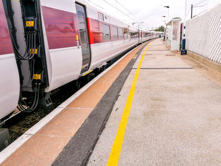 June 09th, 2020 â Retford, United Kingdom. Just one of the hundreds of fast trains, passing Retford Train Station, that run up and down the country taking commuters fast to where they need to get to.のeditorial素材