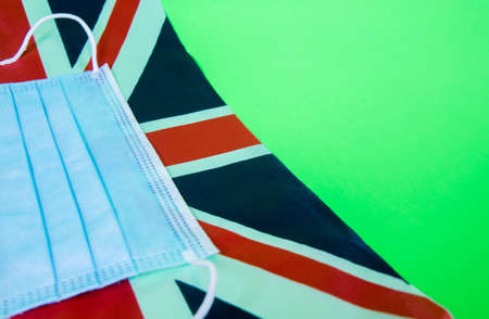 A surgical mask against the United Kingdom's Union Jack flag.