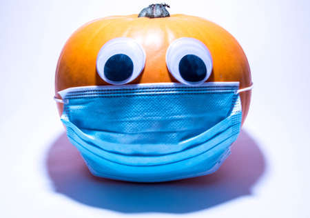 A Halloween pumpkin, with eyes, wearing a surgical mask during the virus pandemic.の写真素材