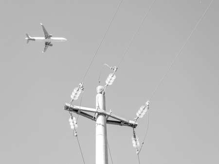 A large passenger aircraft seen from the ground up, high above ground level. Carrying passengers of business and leisure around the world.の写真素材