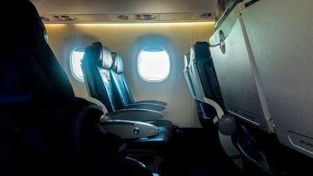 A view along one of the rows on board an airline. The seats empty due to the lack in travel with the...