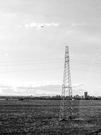 Pylons stretch across the lands of Sicily, Italy, here is just one look at the power source that has been installed to take electric from one location to the next.の写真素材