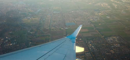 A view from a passenger window of a large aircraft traveling across the world on a holiday or...
