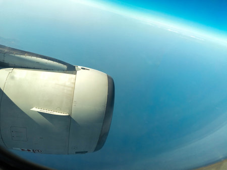 A view from a passenger window of a large aircraft traveling across the world on a holiday or...