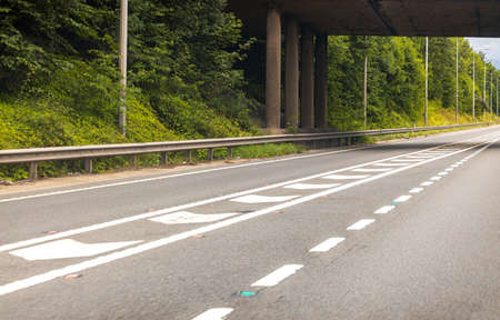 A view from a passenger seat of a vehicle traveling along a motorway in the United Kingdom.の写真素材