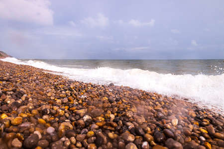 A typical British beach view during a day when there was lots of rain, making it miserable. However still a day when families and people can go and enjoy the sounds of the waves crashing on the shore.の写真素材