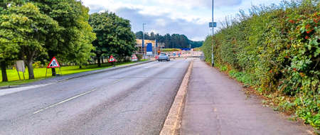 A long British road leading through a small town in England.のeditorial素材