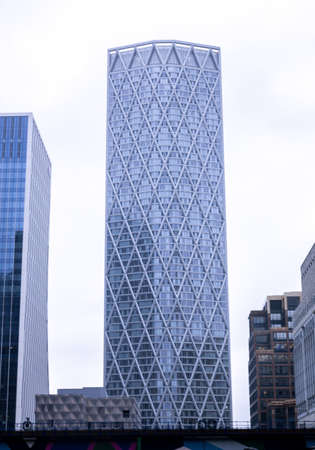 A ground perspective of some high rise buildings in the middle of a large city, in this case London,...