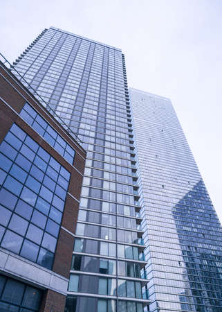 A ground perspective of some high rise buildings in the middle of a large city, in this case London,...