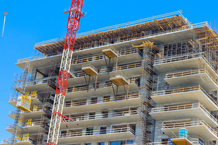 A large crane towers above a city providing easy access to building materials and to transport them...