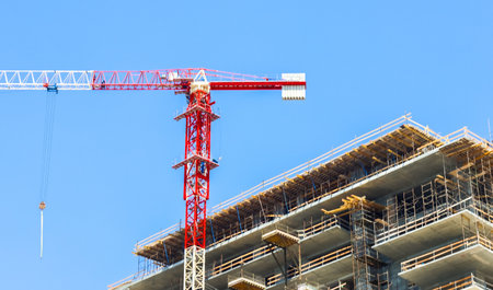 A large crane towers above a city providing easy access to building materials and to transport them...