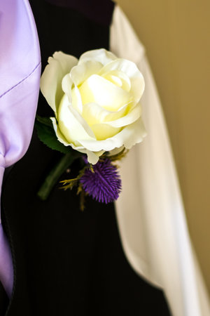 A groom or best man's wedding suit hung up high before it is put on for a wedding ceremony.
